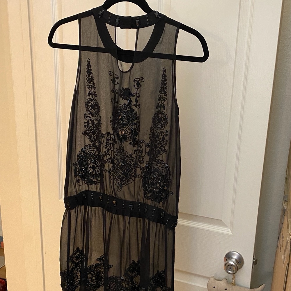 See through dress with lots of black jems